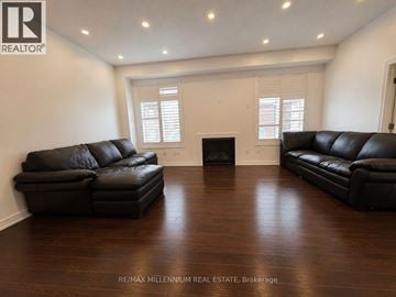 Vaughan (Kleinburg) apartment for rent - A living room with a black leather couch and a fireplace.