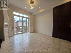 Vaughan (Kleinburg) apartment for rent - A spacious room with a sliding glass door leading to a balcony.
