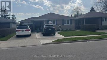 Brampton (Brampton East) apartment for rent - A white car is parked in front of a house with a sign that says "Royal LePage Realty Plus, Brokerage".
