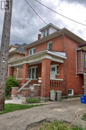 Hamilton (Stipley) apartment for rent - A red brick house with a porch and a small front yard.