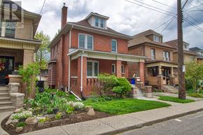 Hamilton (Stipley) apartment for rent - A red brick house with a white window and a sign that says "REALTOR" on the front.