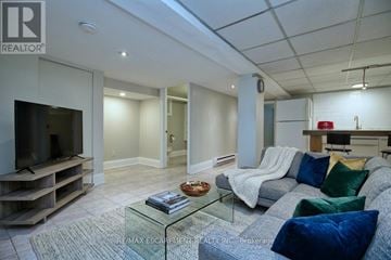 Hamilton (Stipley) apartment for rent - A living room with a grey couch and a glass coffee table.