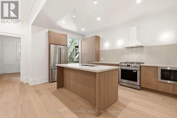 Hamilton (Durand) apartment for rent - A modern kitchen with wooden cabinets and stainless steel appliances.