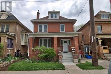 Hamilton (Stipley) apartment for rent - A house with a red brick facade and a grey door.