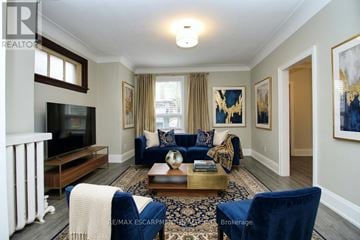 Hamilton (Stipley) apartment for rent - A living room with a blue couch and a television.