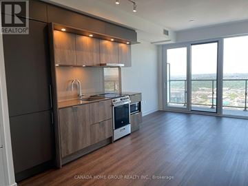 Mississauga (City Centre) condo for rent - A modern kitchen with dark wood cabinets and stainless steel appliances.