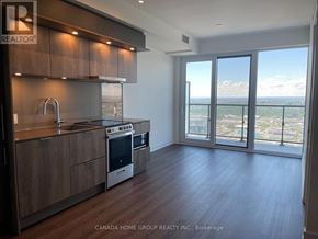 Mississauga (City Centre) condo for rent - A modern kitchen with wooden cabinets and a stainless steel stove top oven.