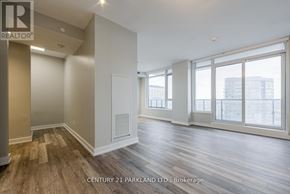 Toronto (High Park-Swansea) condo for rent - A spacious room with wood flooring and large windows.