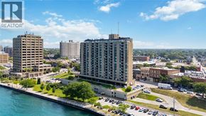 Sarnia condo for rent - A cityscape with a body of water in the foreground and a Realtor logo in the corner.