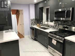 Mississauga (Meadowvale) apartment for rent - A modern kitchen with black cabinets and stainless steel appliances.