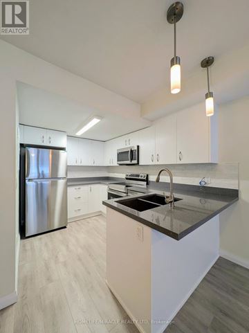 Cambridge townhouse for rent - A modern kitchen with a stainless steel refrigerator and a dark countertop.