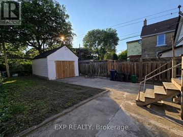 Toronto (Danforth) apartment for rent - A backyard with a shed, a fence, and a deck.