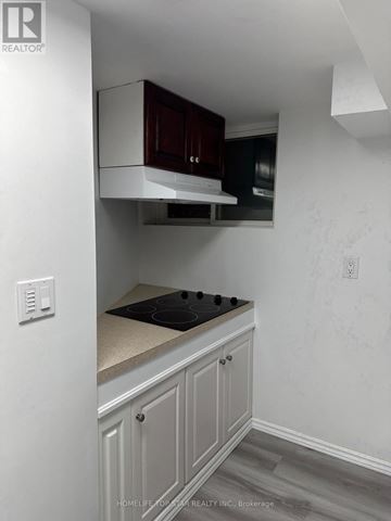 Toronto (Newtonbrook West) apartment for rent - A kitchen with a stove top oven and cabinets above it.