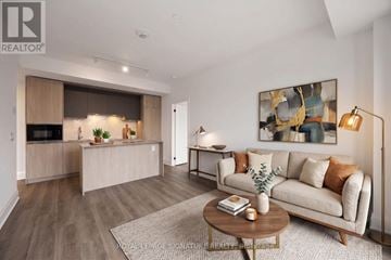 Toronto (Waterfront Communities) condo for rent - A living room with a couch, coffee table, and a painting on the wall.