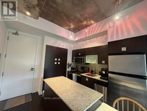 Toronto (Waterfront Communities) condo for rent - A kitchen with a refrigerator, microwave, and oven.
