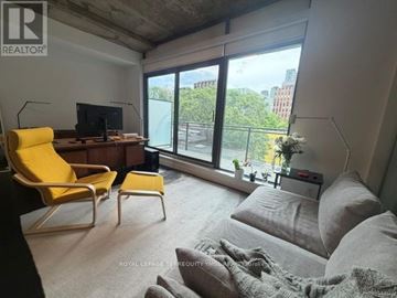 Toronto (Waterfront Communities) condo for rent - A living room with a yellow chair and grey couch.