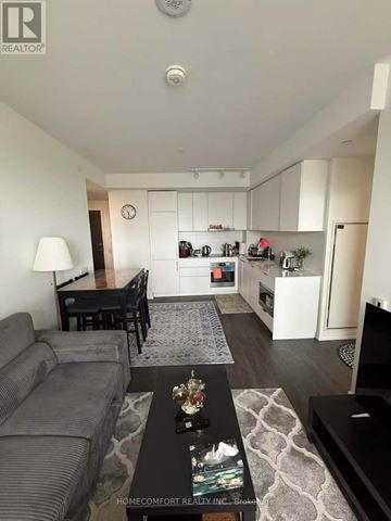 Toronto (Newtonbrook East) condo for rent - A kitchen with white cabinets and a black stove top oven.