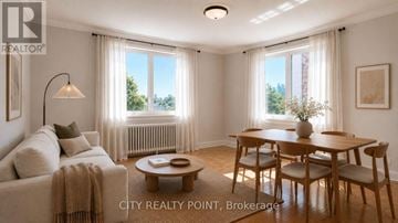 Toronto (Casa Loma) condo for rent - A well-lit living room with a couch, coffee table, and dining table.