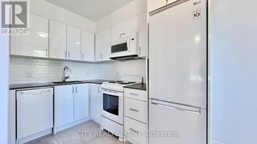 Toronto (Casa Loma) condo for rent - A kitchen with white appliances and cabinets.