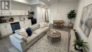 Toronto (Humber Summit) apartment for rent - A living room with a grey couch and a coffee table.