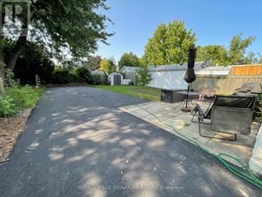 Hamilton (Inch Park) apartment for rent - A residential street with a driveway and a lawn chair.