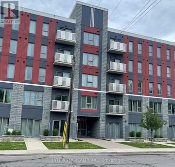 Hamilton (Ainslie Wood) condo for rent - A multi-story apartment building with balconies and a sign for Intercity Realty INC.