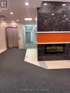 Hamilton (Ainslie Wood) condo for rent - A hallway with a marble wall and a grey carpet.