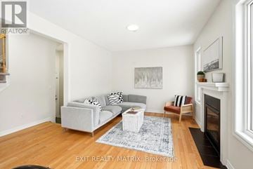 Ottawa apartment for rent - A living room with a grey couch and a fireplace.