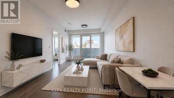 Toronto (Forest Hill North) condo for rent - A modern living room with a flat screen TV, a long sofa, and a coffee table.