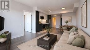 Toronto (Forest Hill North) condo for rent - A modern living room with a large couch and a coffee table.