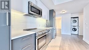 Toronto (Forest Hill North) condo for rent - A modern kitchen with stainless steel appliances and a microwave above the stove.