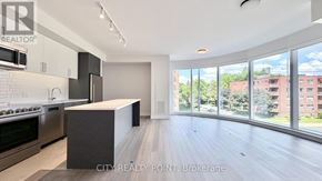 Toronto (Forest Hill North) condo for rent - A modern kitchen with stainless steel appliances and a large island.