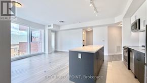 Toronto (Forest Hill North) condo for rent - A kitchen area with a refrigerator, microwave, and oven.
