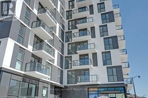 Oakville (Jm Joshua Meadows) condo for rent - A modern multi-story building with balconies and a sign for Brokerage Realty Inc.