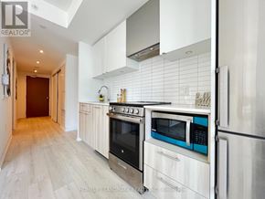 Toronto (Moss Park) condo for rent - A kitchen with a stove top oven and microwave.