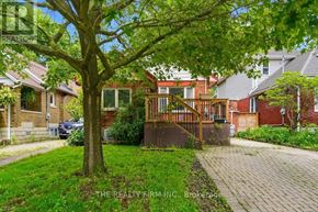 London South (South E) apartment for rent - A tree in a yard with a house in the background.