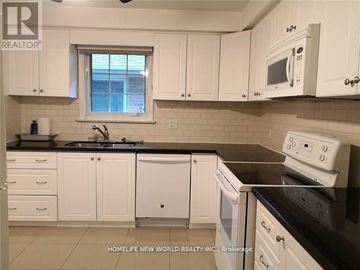 Toronto (Bayview Village) apartment for rent - A kitchen with white cabinets and black countertops.