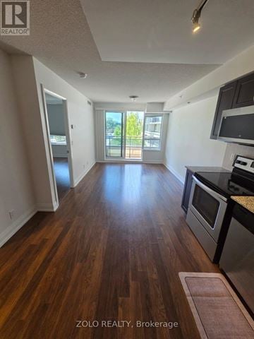 Richmond Hill (Doncrest) condo for rent - A kitchen with wood floors and a view of a balcony.