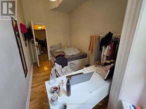 Toronto (Kensington-Chinatown) multi-family for rent - A bedroom with a bed, a desk, and a closet.