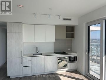 Vaughan (Vaughan Corporate Centre) condo for rent - A kitchen with white cabinets and a sink.