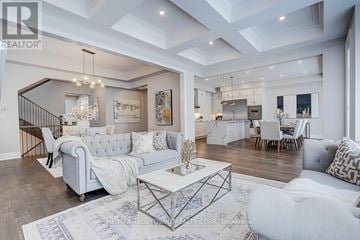 Oakville (Jm Joshua Meadows) apartment for rent - A spacious living room with a white sofa set and a chandelier.