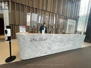Toronto (North St. James Town) condo for rent - A reception desk with a person standing behind it.