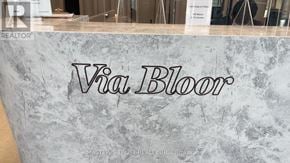 Toronto (North St. James Town) condo for rent - A sign that says "Via Bloor" is displayed on a marble-like surface.