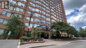 Burlington (Brant) condo for rent - A tall building with a glass facade and a sign that reads "REALTOR".
