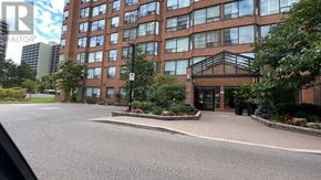 Burlington (Brant) condo for rent - A building with a glass facade and a brick facade with a tree in front of it.