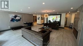 Burlington (Brant) condo for rent - A living room with a large couch and a painting on the wall.