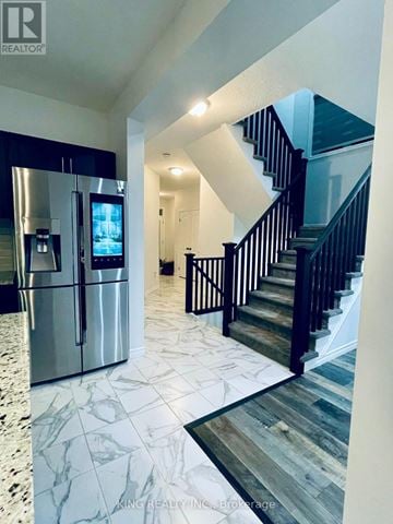 London South (South U) apartment for rent - A modern kitchen with a refrigerator and stairs in the background.