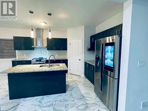 London South (South U) apartment for rent - A kitchen with black cabinets and a granite countertop.