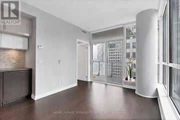 Toronto (Waterfront Communities) condo for rent - A spacious room with a large window and a view of a building outside.