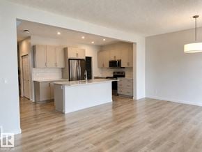 Edmonton apartment for rent - A kitchen with a white island and wooden floors.